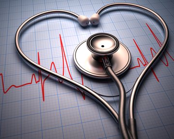 Ein Stethoskop in Herzform liegt auf einer Grafik von Herztönen.