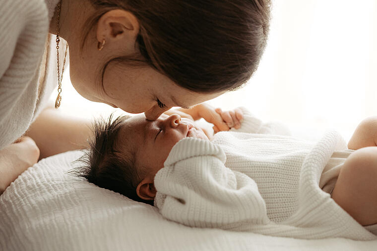 Klinikreportage am St. Josefskrankenhaus Freiburg, Mutter küsst Baby auf Stirn, Marina Müller Fotografie